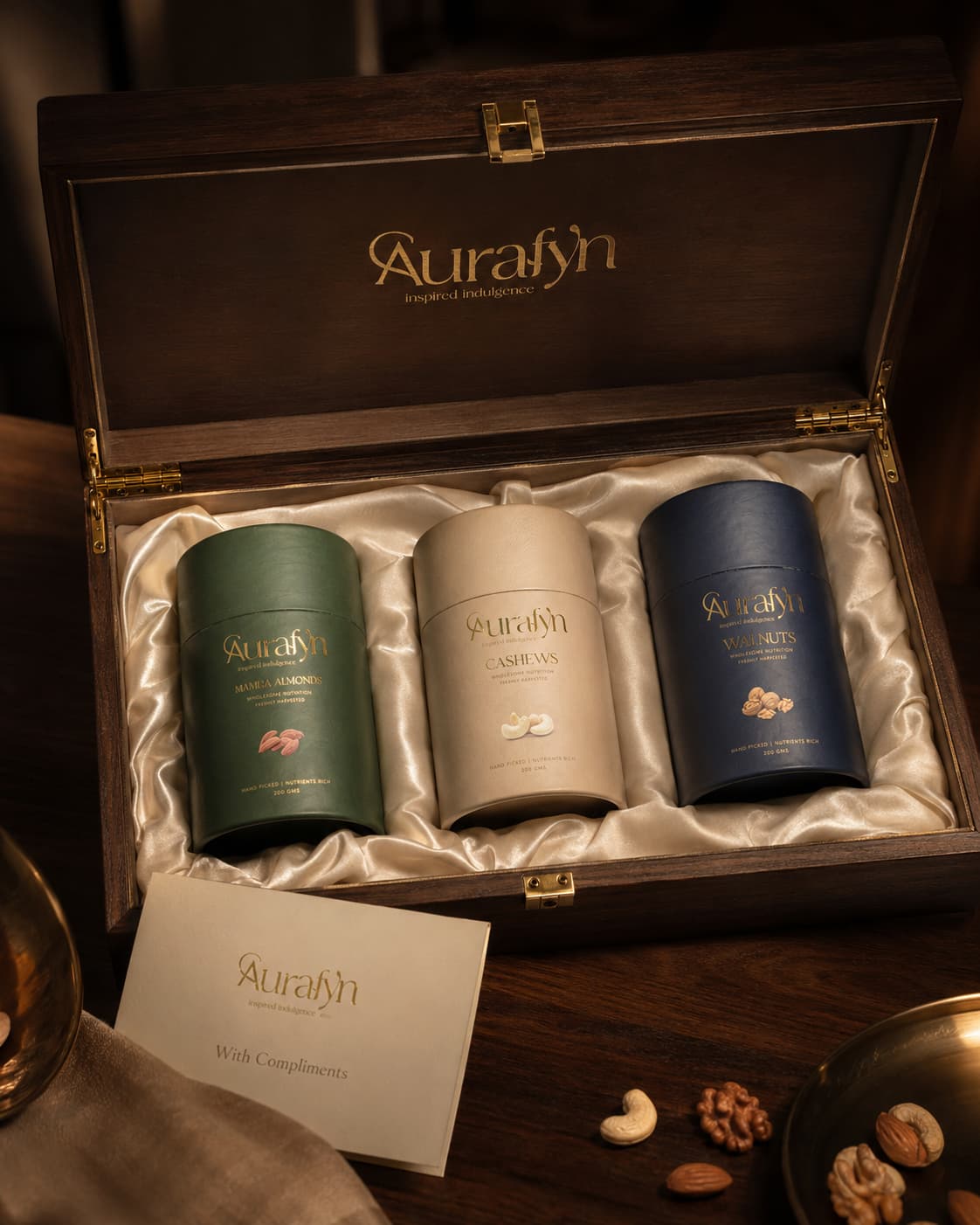 A row of Aurafyn gift boxes tied with gold cord, each with a handwritten tag